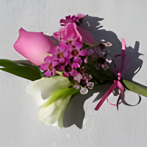 Wrist corsage with ballet pink rose, freesia, waxflower